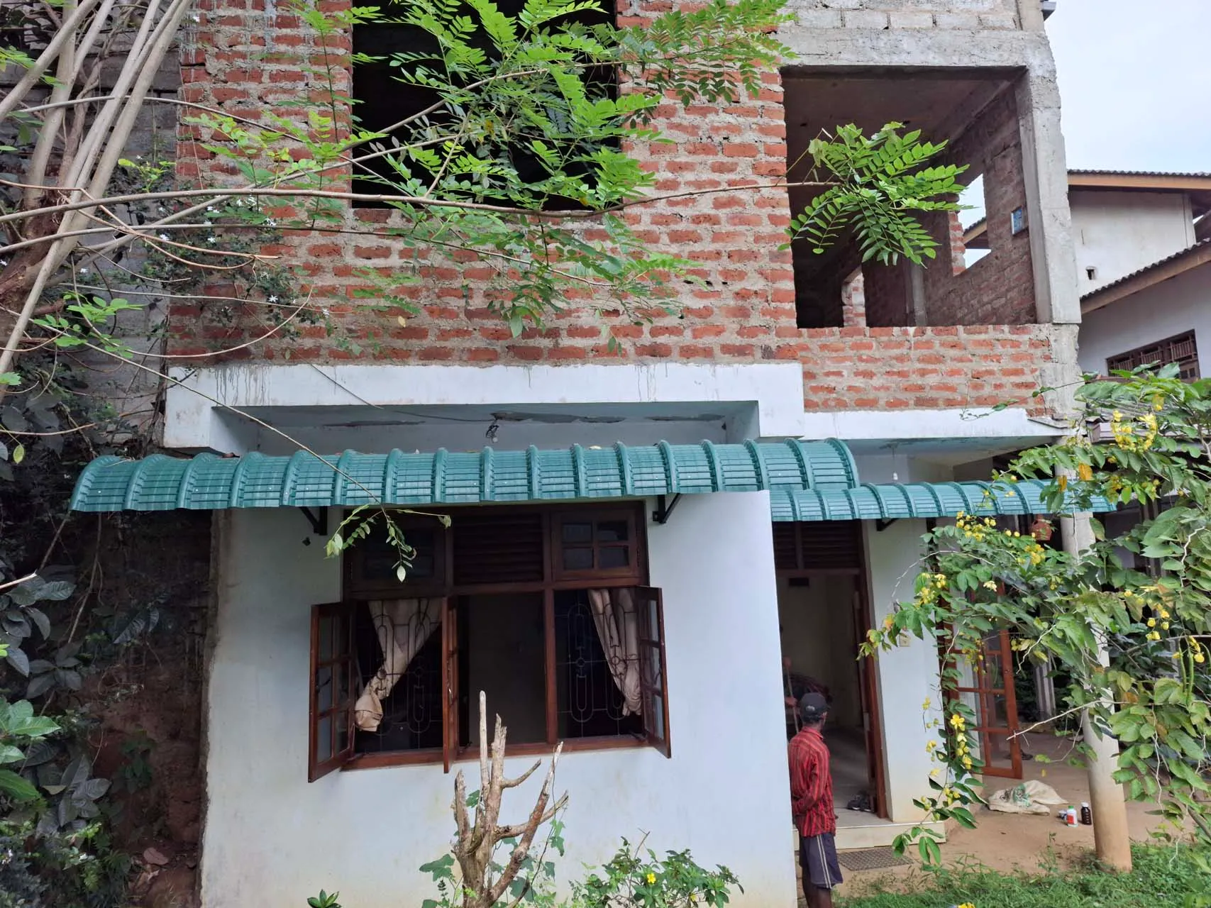 Another view of the house entrance and surrounding garden