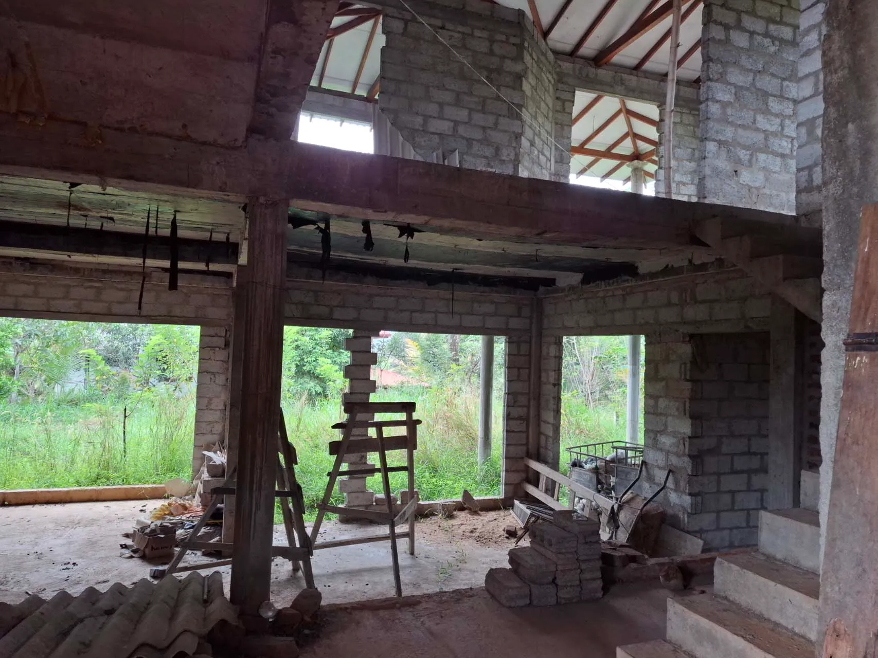 Unfinished second-floor living area with block walls and large openings