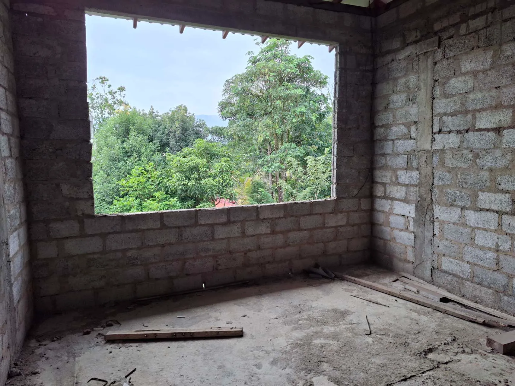 Unfinished master bedroom opening toward the surrounding trees